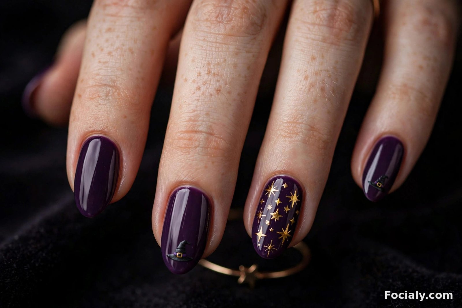 Deep purple Halloween nails with tiny witch hats and gold stars