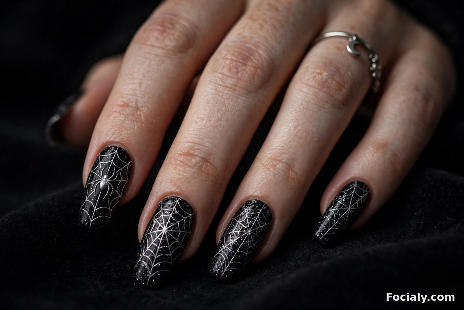 Black glitter Halloween nails with silver spiderweb lines