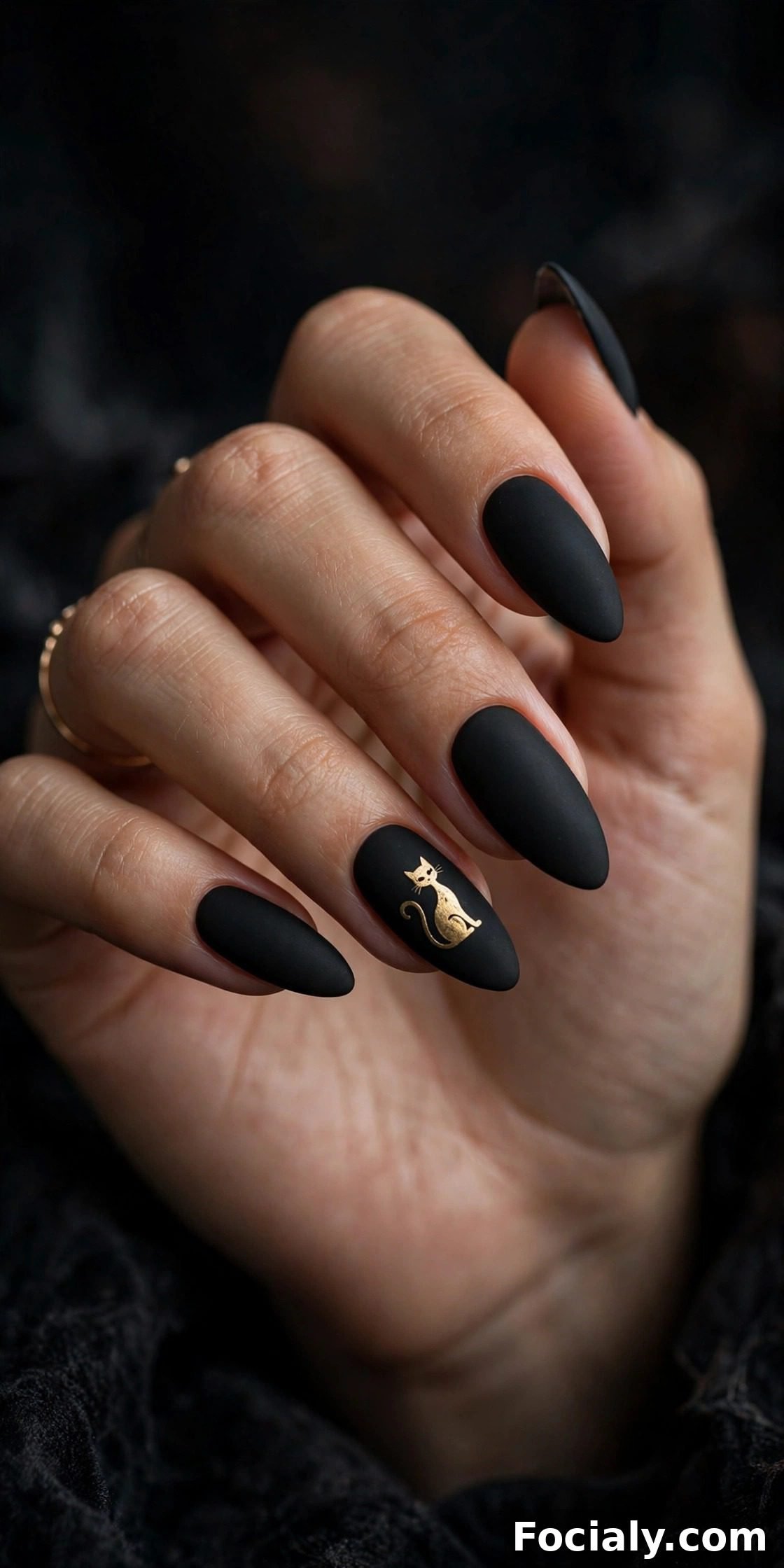 Matte black almond nails with a gold black cat silhouette - Halloween nails design