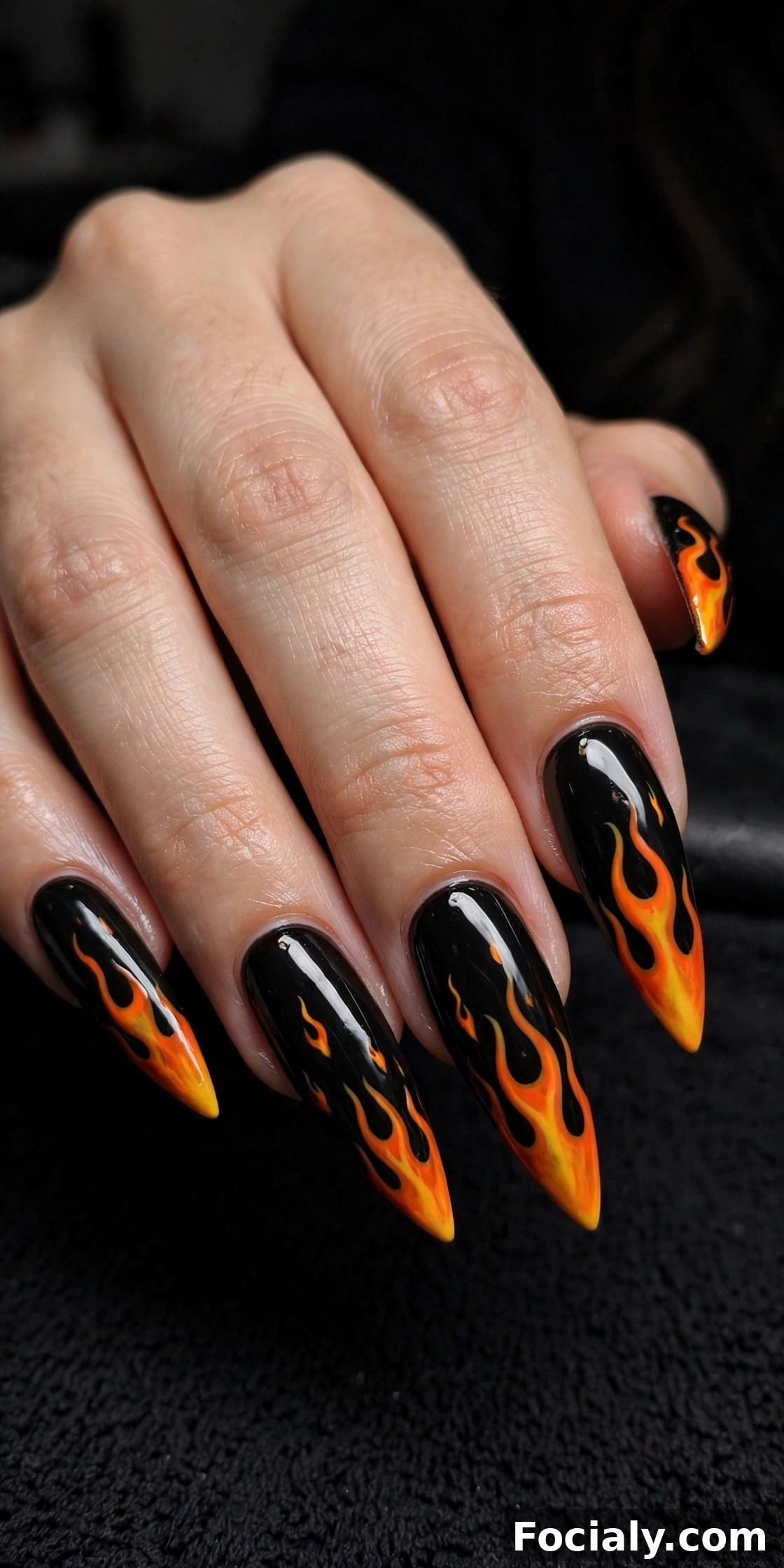 Black stiletto nails with orange and yellow flame tips - Halloween nails design