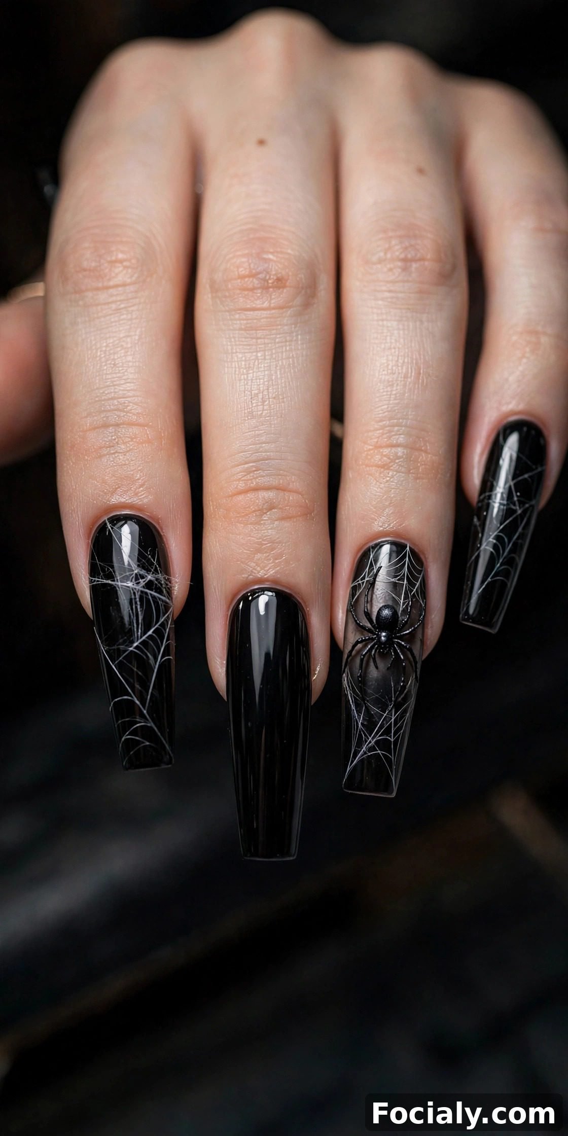 Glossy black nails with spider and web accent nail art - Halloween nails design