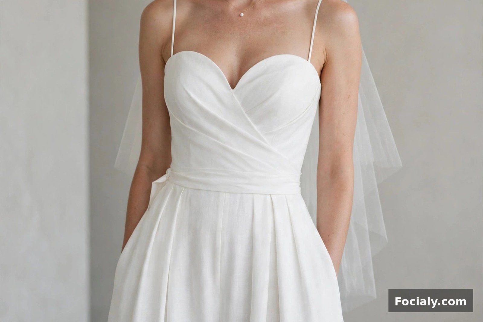 Bride wearing an elegant white wide-leg jumpsuit with a sweetheart neckline