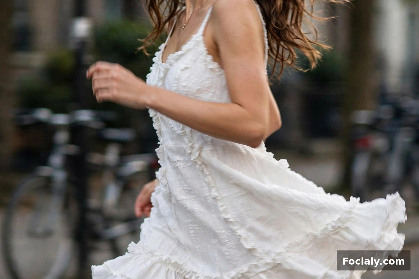Woman in a white mini dress with a ruffled hem