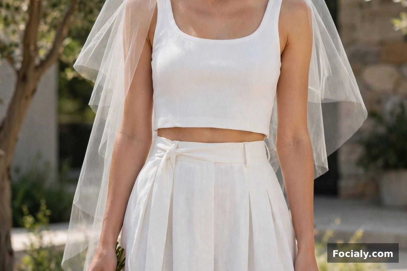 Bride in a white cropped top and high-waisted midi skirt set