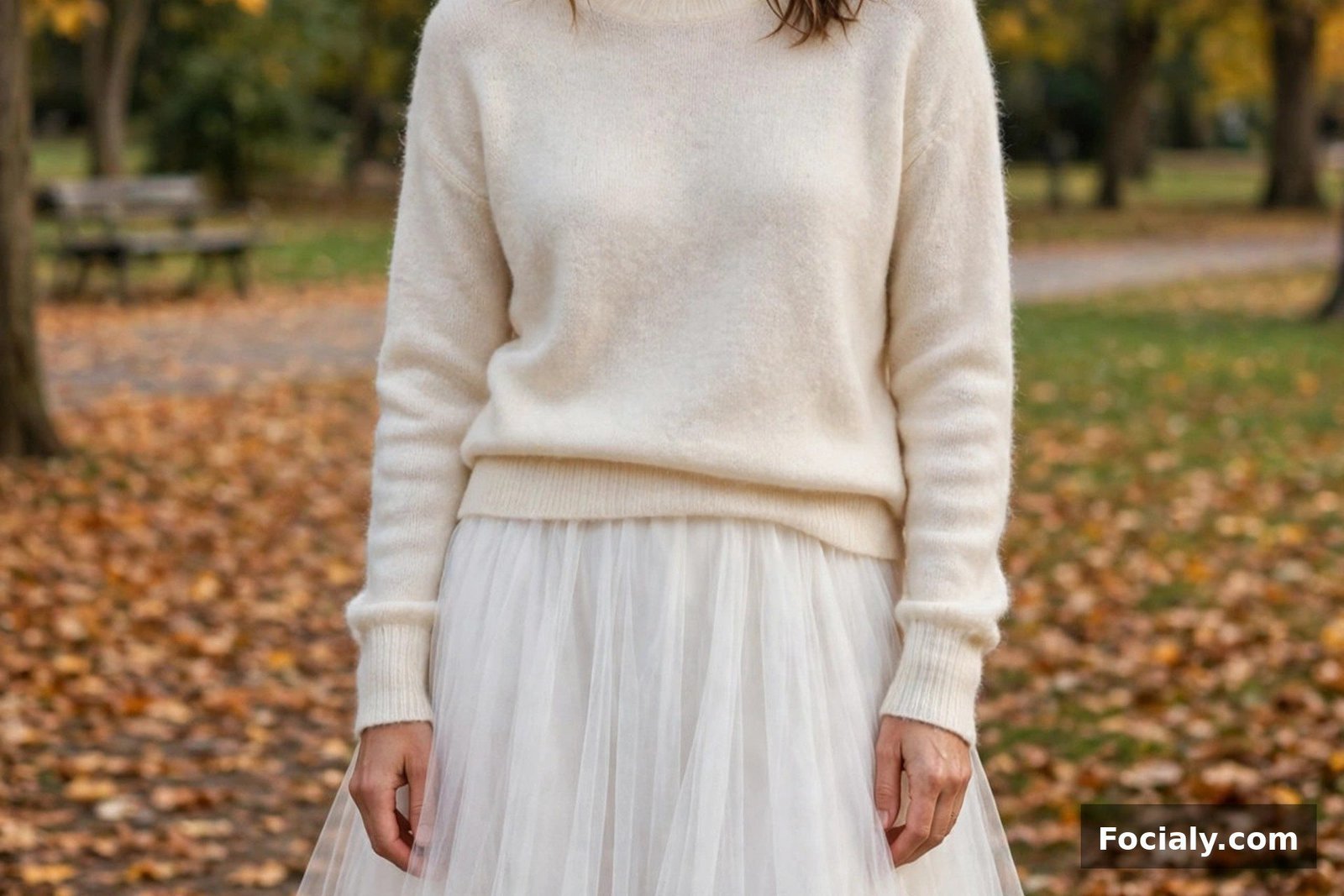 Woman in a white tulle skirt and cream cashmere sweater